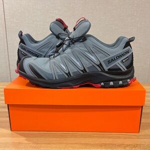 Salomon Grey and Black Trail Sneakers with Red Accents